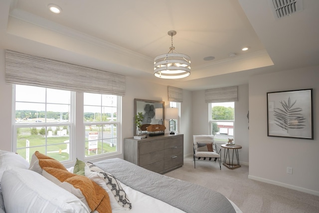 bedroom featuring light carpet, a tray ceiling, and ornamental molding