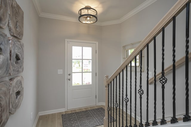 entryway featuring a notable chandelier, crown molding, and wood-type flooring