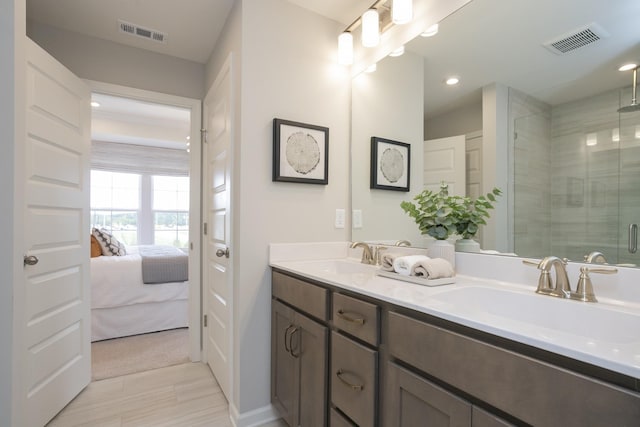 bathroom with vanity and a shower with shower door