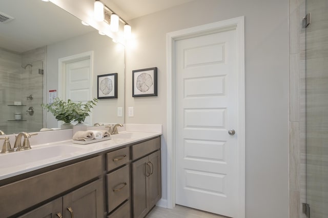 bathroom featuring vanity and a shower with shower door