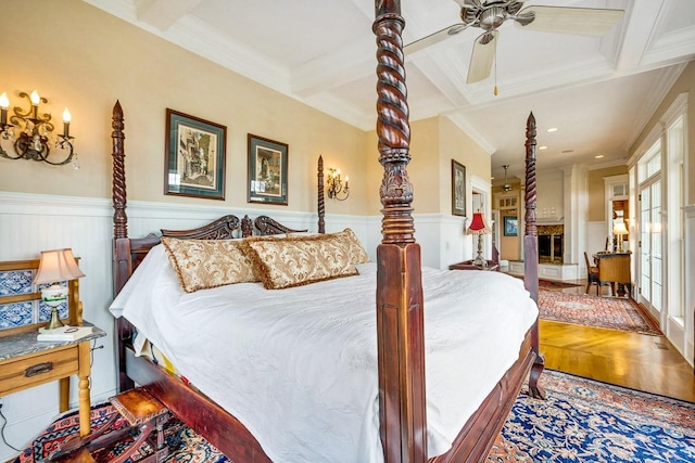 bedroom with coffered ceiling, crown molding, wood-type flooring, ceiling fan, and beam ceiling