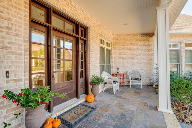 view of exterior entry featuring covered porch