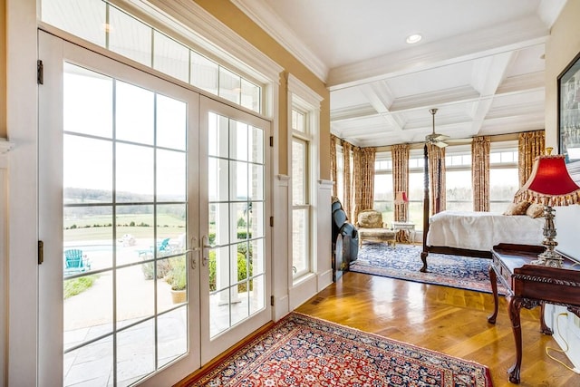 bedroom with coffered ceiling, wood-type flooring, access to outside, ornamental molding, and beamed ceiling