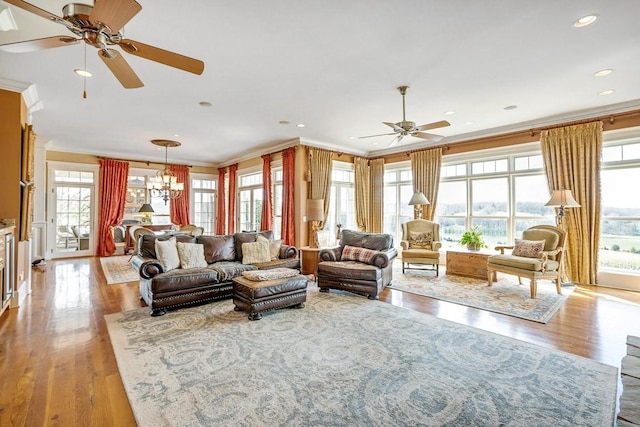 living room featuring ornamental molding, light wood-type flooring, and plenty of natural light