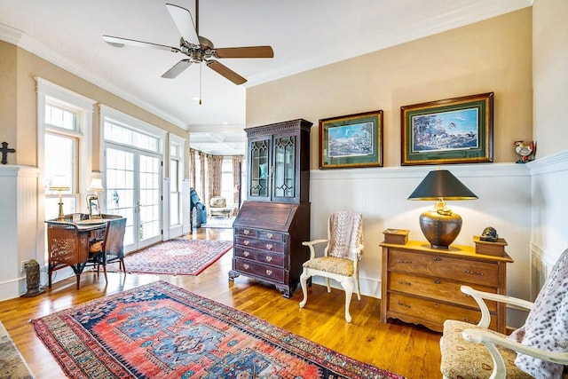 sitting room with french doors, ceiling fan, ornamental molding, and hardwood / wood-style floors