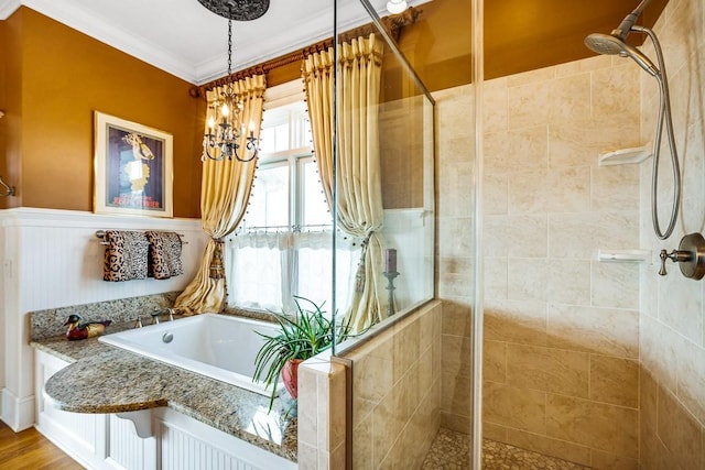 bathroom with hardwood / wood-style flooring, ornamental molding, separate shower and tub, and a notable chandelier