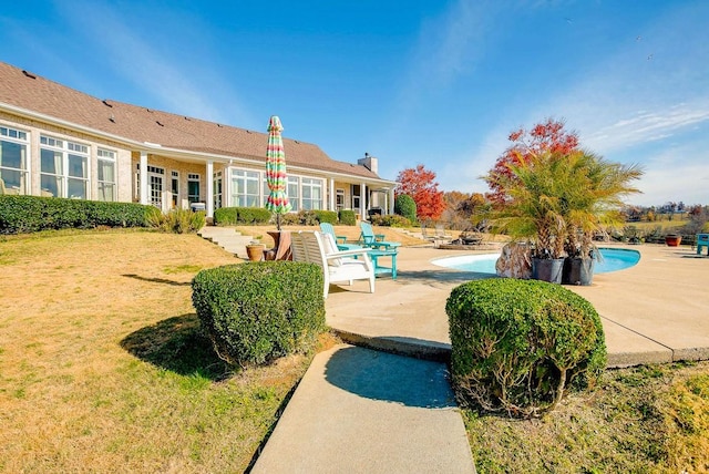 view of pool featuring a patio area and a lawn