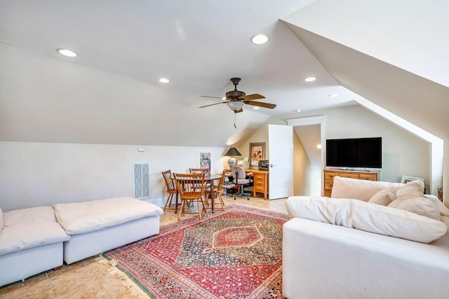 living room with ceiling fan, vaulted ceiling, and light tile patterned floors