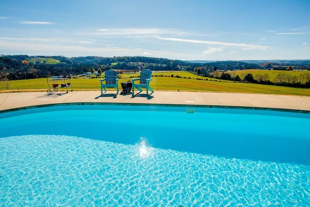 view of pool featuring a patio area and a lawn