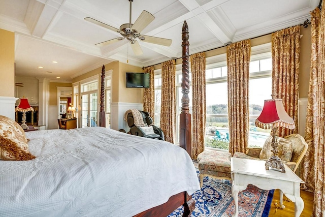 bedroom featuring coffered ceiling, ornamental molding, hardwood / wood-style flooring, ceiling fan, and beam ceiling