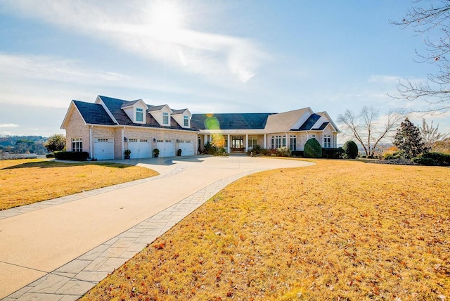 view of front of property featuring a garage and a front lawn