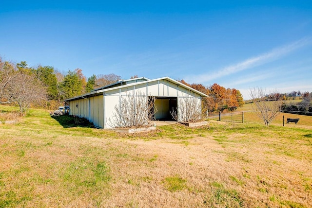 view of outdoor structure with a yard and a rural view