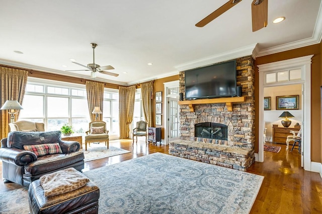 living room with ceiling fan, a fireplace, ornamental molding, and dark hardwood / wood-style floors