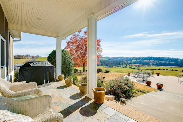 view of patio with area for grilling and a rural view