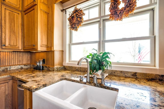 kitchen featuring sink and light stone counters