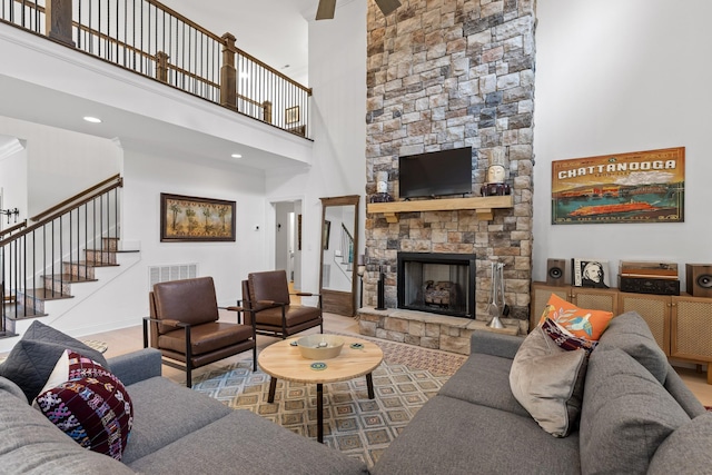 living room with a fireplace and a high ceiling