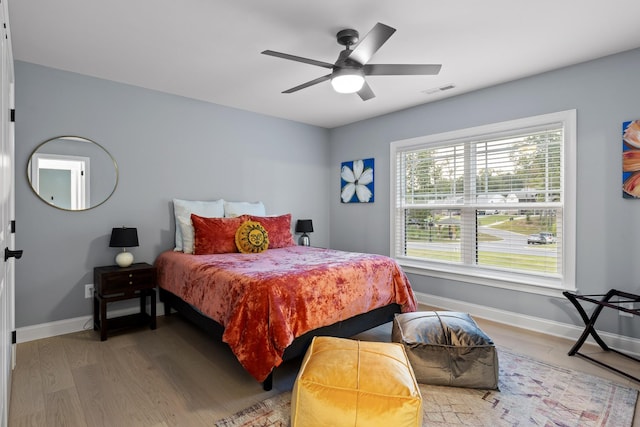 bedroom featuring light hardwood / wood-style floors and ceiling fan