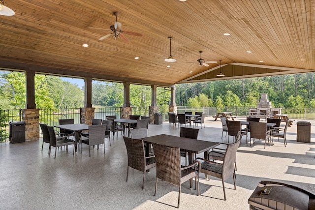 view of patio / terrace with ceiling fan and an outdoor stone fireplace