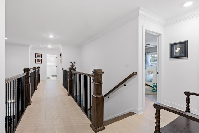 hall with ornamental molding and light wood-type flooring