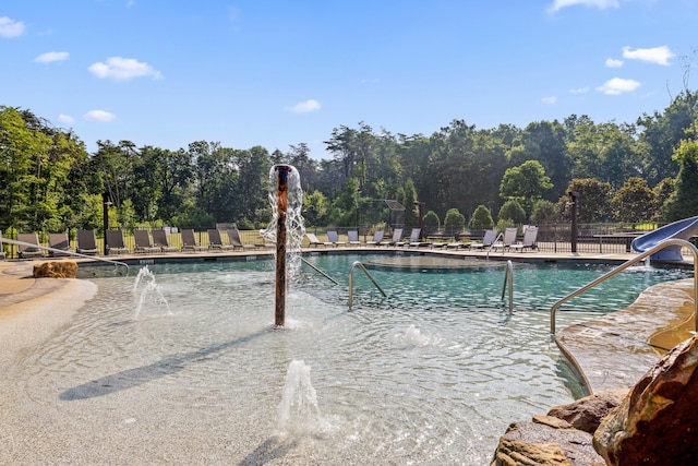 view of pool with pool water feature