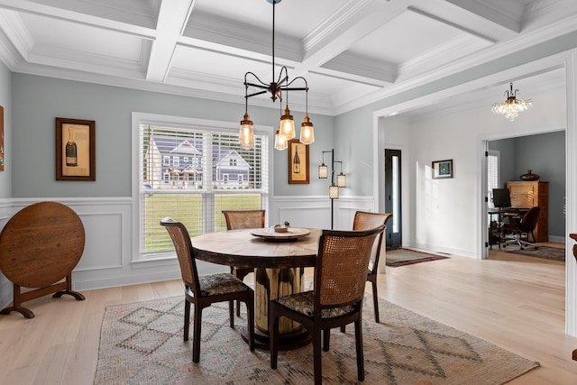 dining space featuring beamed ceiling, coffered ceiling, light hardwood / wood-style flooring, and crown molding