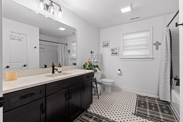 full bathroom featuring shower / tub combo with curtain, vanity, toilet, and plenty of natural light