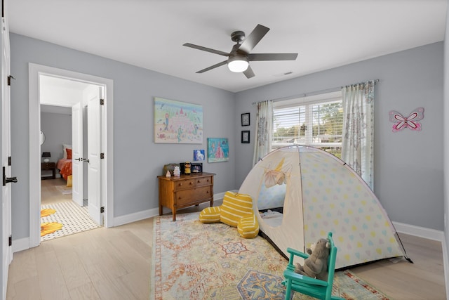 bedroom with ceiling fan and light hardwood / wood-style flooring