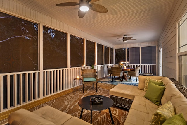 sunroom / solarium featuring ceiling fan