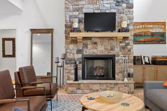 living room featuring a stone fireplace