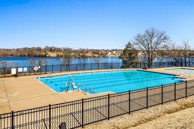 view of swimming pool featuring a patio area and a water view