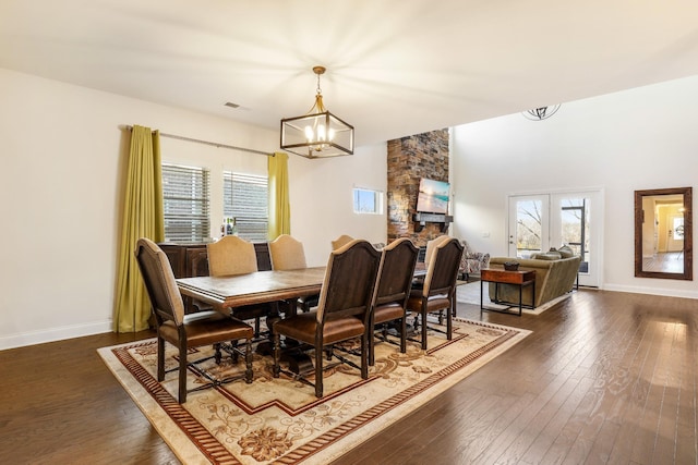 dining space with dark wood-type flooring and a chandelier