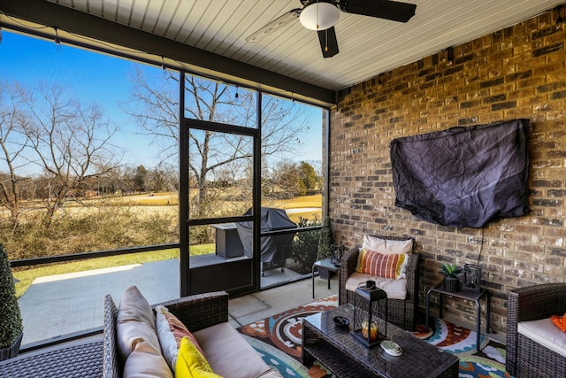 sunroom / solarium featuring ceiling fan