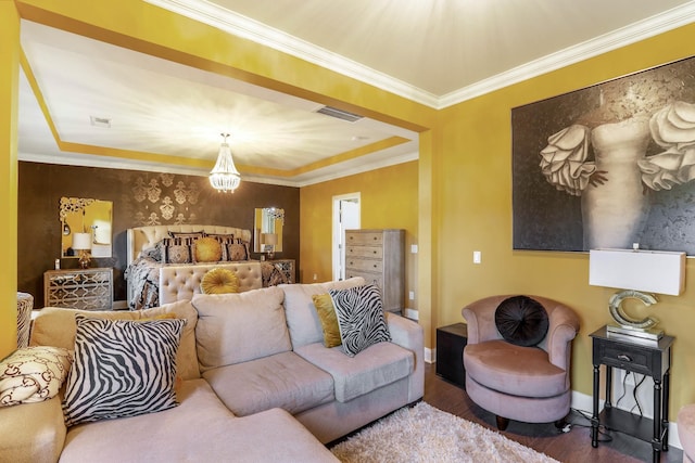 living room with crown molding, a chandelier, and hardwood / wood-style floors