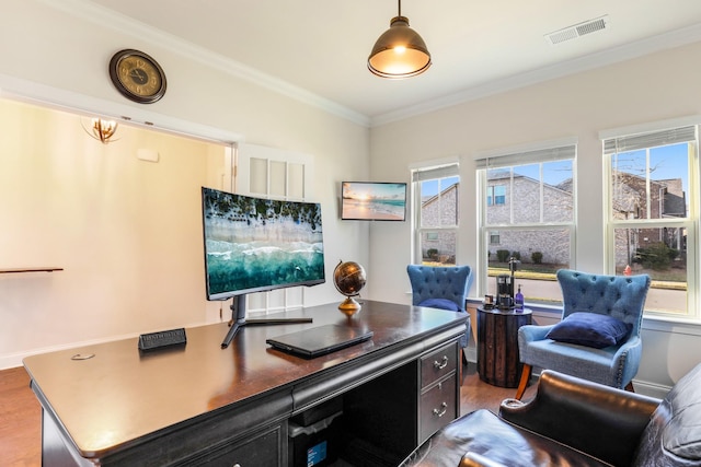 office area with wood-type flooring, a wealth of natural light, and crown molding