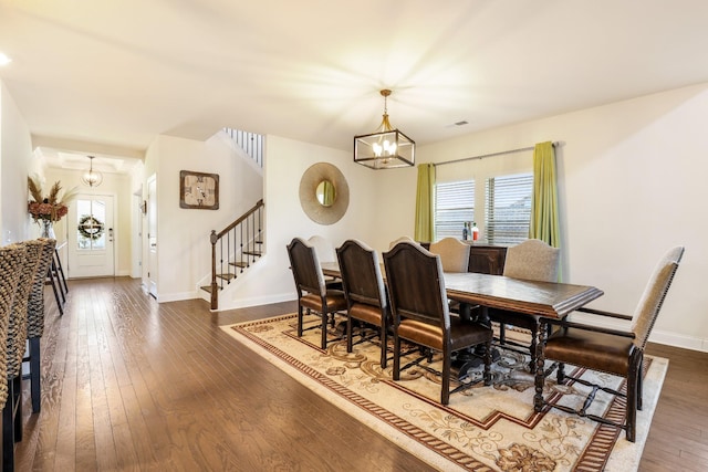 dining room featuring dark hardwood / wood-style flooring and a chandelier