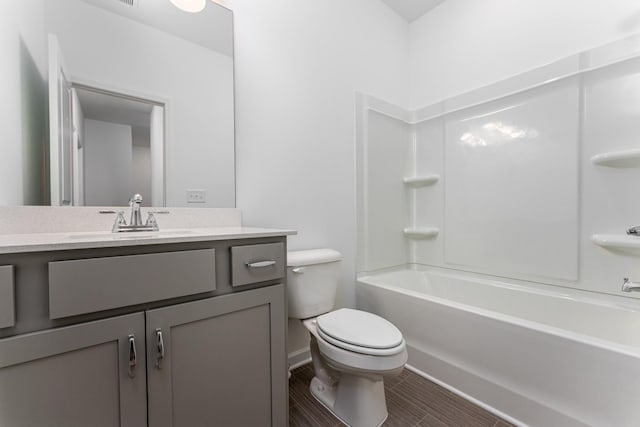 full bathroom featuring vanity, washtub / shower combination, and toilet