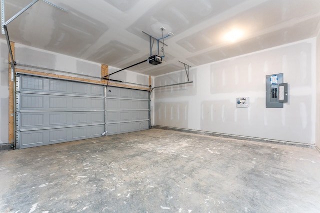 garage with a garage door opener and electric panel