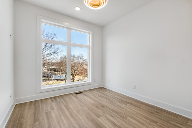 spare room with light hardwood / wood-style floors