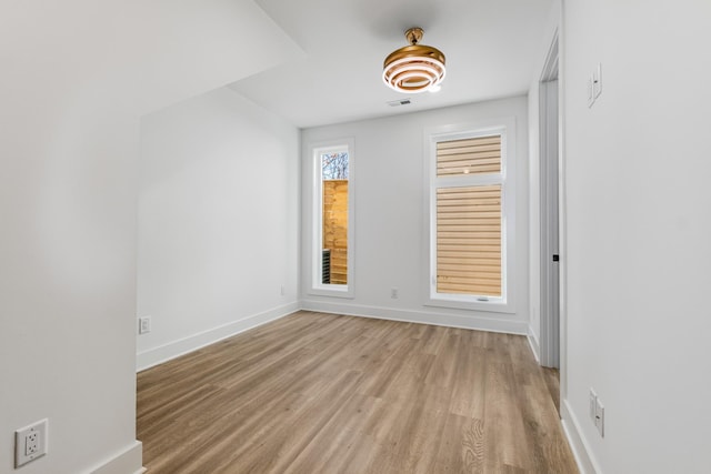 unfurnished room with light wood-type flooring