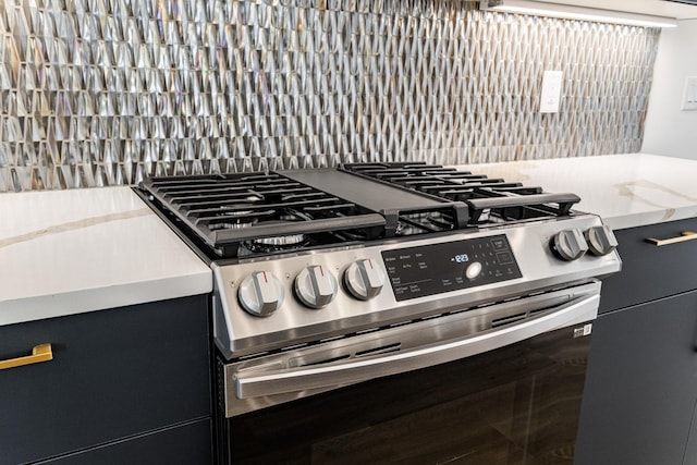 room details featuring decorative backsplash and stainless steel gas range