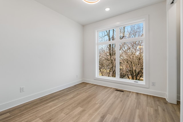 unfurnished room with light hardwood / wood-style flooring