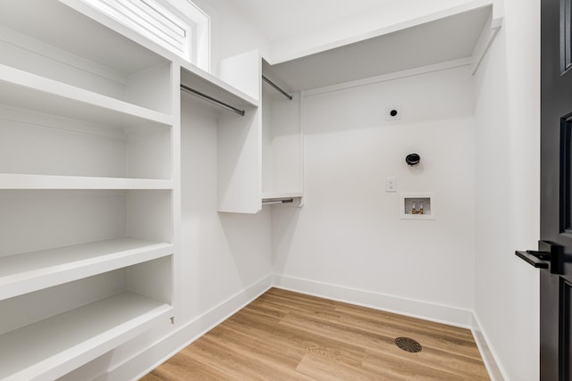 walk in closet featuring light hardwood / wood-style flooring