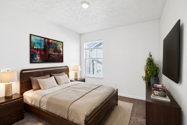 carpeted bedroom with a textured ceiling and baseboards