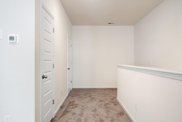 hallway with light colored carpet