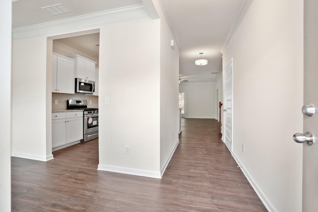 hall with dark wood-type flooring and ornamental molding