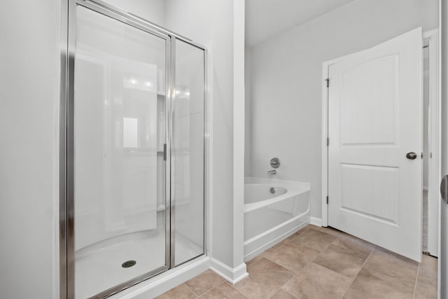 bathroom with tile patterned floors and plus walk in shower