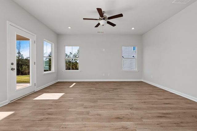 empty room with light hardwood / wood-style floors and ceiling fan