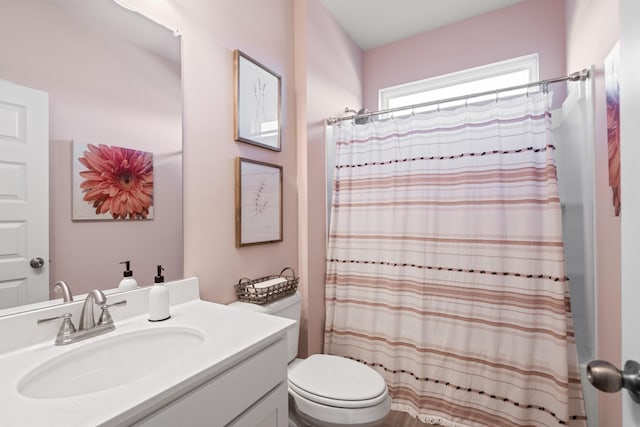 bathroom with vanity, curtained shower, and toilet