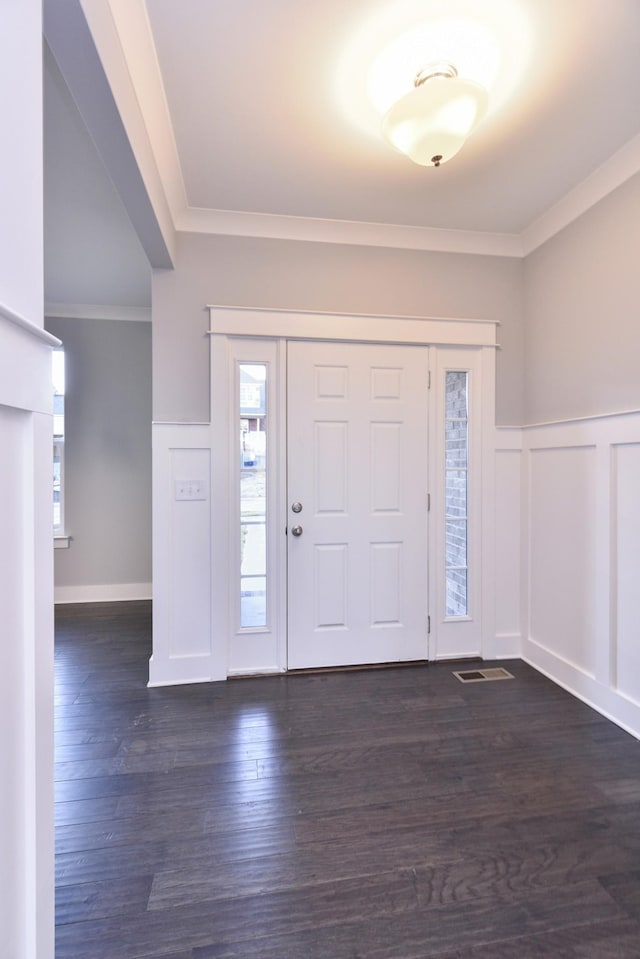 entryway featuring crown molding and dark hardwood / wood-style floors