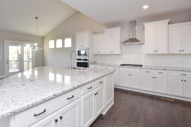 kitchen featuring white cabinetry, sink, stainless steel appliances, and wall chimney exhaust hood